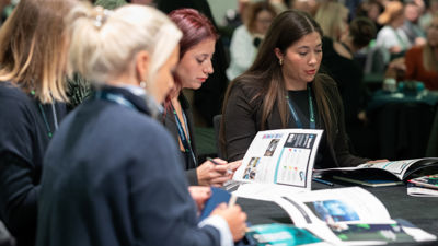 People Sitting around a table reading a brochure