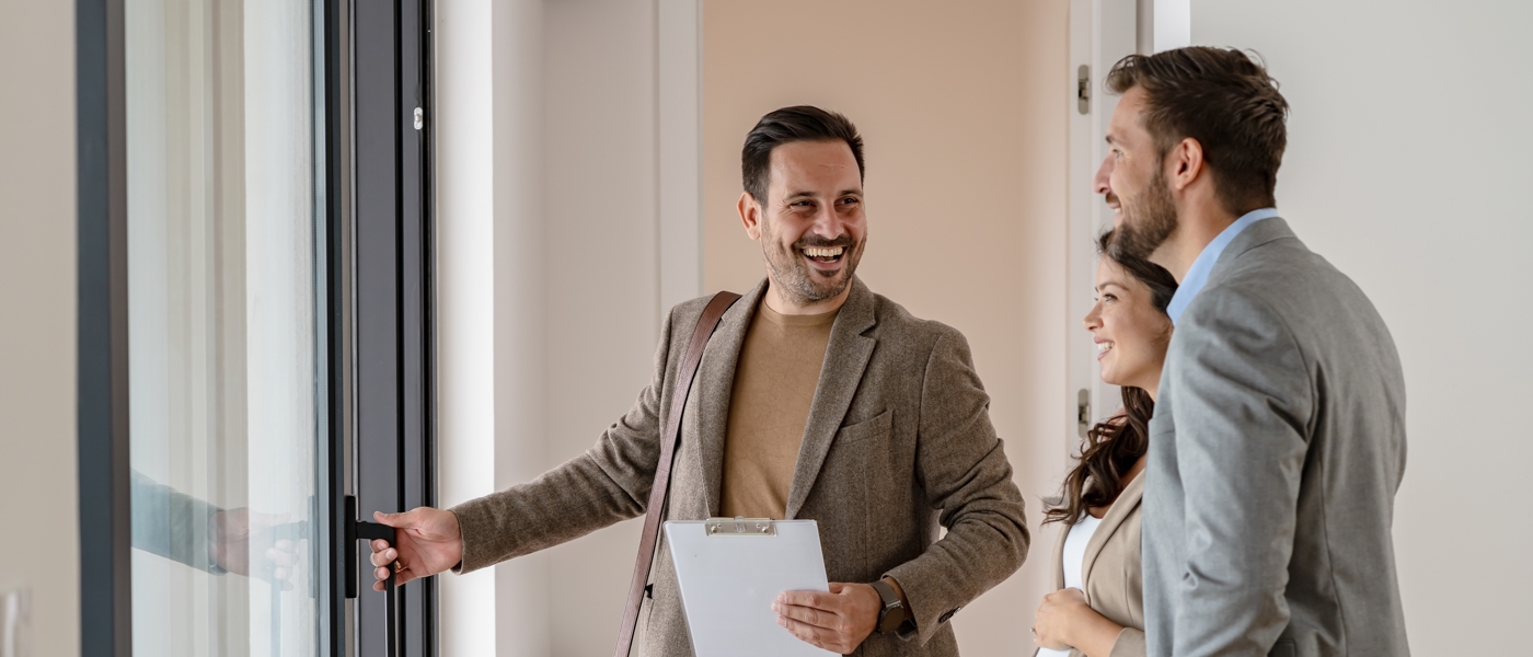 A property manager holding a door in a new apartment