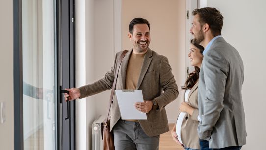 A property manager holding a door in a new apartment